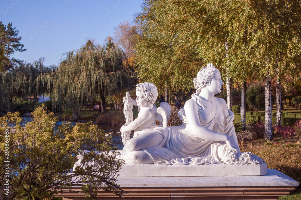 Wall mural ancient statue of aphrodite and cupid in the park