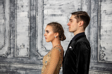 young couple in evening dance costumes posing in the dance hall