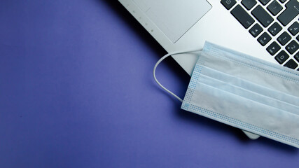 I work from home with a mask on the computer and headphones