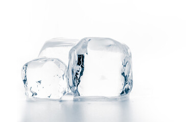 Ice cubes on white surface, isolated on white.