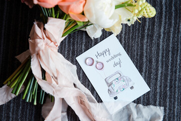 Wedding postcard with two rings near bridal bouquet
