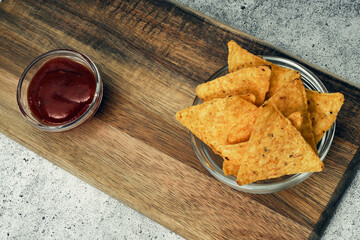 Corn cheese, snacks with sauce on a wooden stand. Beer snack, dish on the menu. Close up.