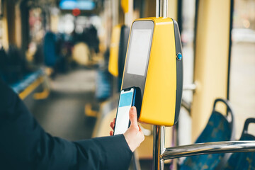 Girl paying by phone for the tram ticket. Payment by phone. 