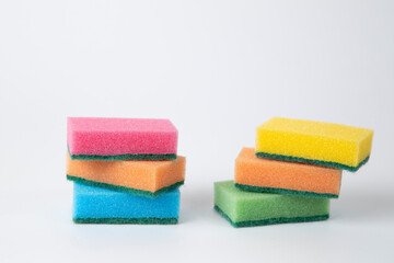 Colored sponges for washing dishes on a white background.