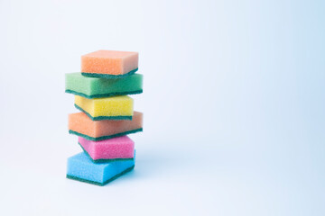 Colored sponges for washing dishes on a white background.