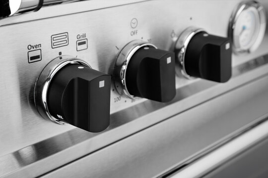 Close up image of stainless steel cooker controls