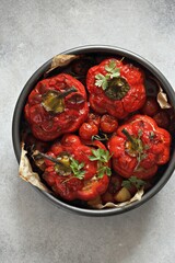 Oven backed red paprika stuffed with meat and vegetables. Overhead view, selective focus