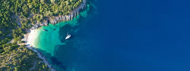 Foto auf Acrylglas Aerial drone top down ultra wide photo of luxury yacht anchored in tropical exotic island turquoise sea © aerial-drone