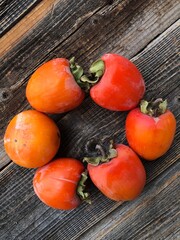 Ripe juicy persimmon on a wooden table