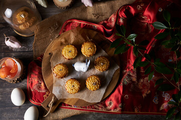 Mooncake a Chinese traditional pastry for Mid-Autumn festival. set on rustic wooden table.