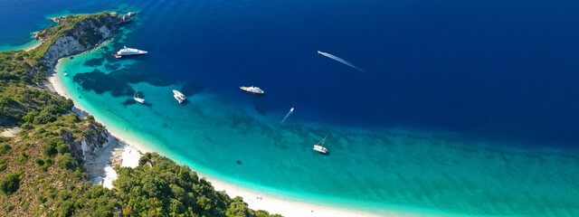 Aerial drone top down ultra wide photo of luxury yacht anchored in tropical exotic island turquoise...
