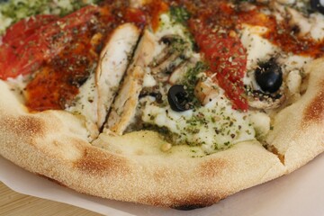 Italian pizza with chicken tomatoes and cheese