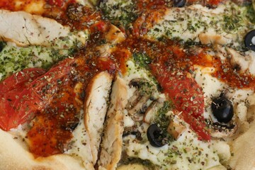 Italian pizza with chicken tomatoes and cheese