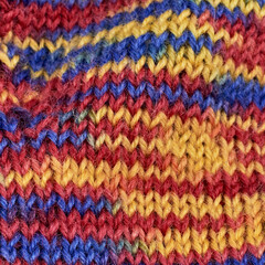 Fototapeta na wymiar motley multicolor wool knitted warm handmade sock as a gift for the new year