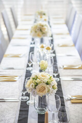 wedding table with flowers and decorations, wedding centerpiece or event reception in modern style
