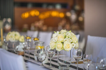 wedding table with flowers and decorations, wedding centerpiece or event reception in modern style