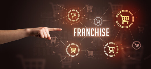 Close-Up of cropped hand pointing at FRANCHISE inscription, online shopping concept