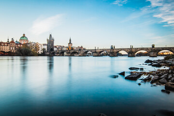 The Charles Bridge at sunset on long exposure with vltava river in foreground, Prague, Czech Republic,