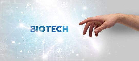 Hand pointing at BIOTECH inscription, modern technology concept