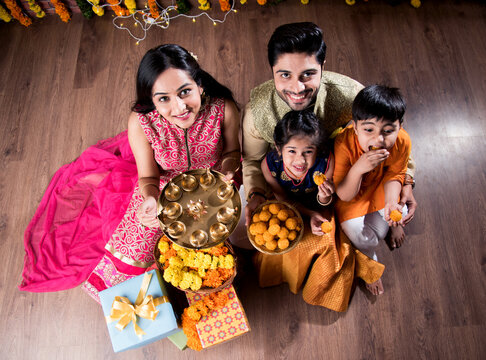Asian Indian young family of four celebrating Diwali, Bhai Dooj or Raksha Bandhan