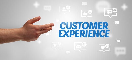 Close-Up of cropped hand pointing at CUSTOMER EXPERIENCE inscription, social networking concept