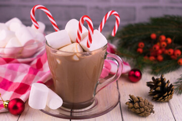 
Cup with Christmas cocoa with marshmallows on the background of Christmas decorations.