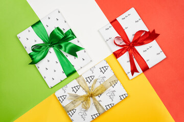 X-mas gift wrapped in paper with Christmas prints and tied with black ribbon. Christmas present box on white background