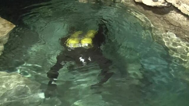 In a small, shallow underground lake located at the very bottom of an airy karst cavity, speleodivers are preparing for a long dive into the Orda underwater cave.