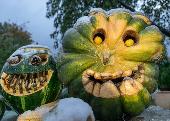 first snow, carved decorative pumpkins in the garden, first snow on pumpkin decors, halloween, pumpkin decor