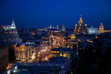 Panoramic photo. Evening or night illuminated building of Moscow Garden Ring on deep blue sky.