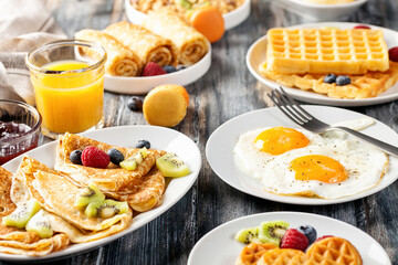 Breakfast - fried eggs, pancakes, crepes, croissants