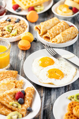 Breakfast - fried eggs, pancakes, crepes, croissants