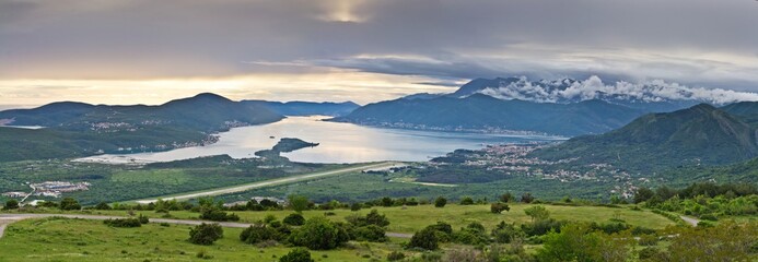 Fototapeta na wymiar The panoramic view on the Tivat airport and green mountains around the Bay of Kotor in Montenegro.