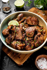 Fried chicken liver with onions and herbs. 