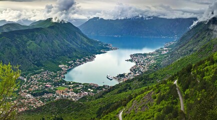 Fototapeta na wymiar Picturesque view of the Bay of Kotor: mountains covered with forests surround small towns in the lowland in Montenegro.