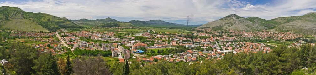 Fototapeta na wymiar The aerial view on old Trebinje city in the lowland surrounded with mountains in summer against cloudy sky in Bosnia and Herzegovina.