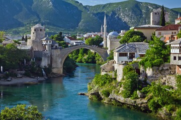 View on Mostar city with old bridge (Stari Most) over the Neretva river and other white stone...