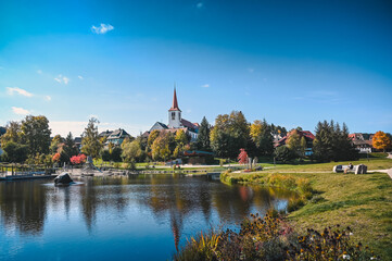 Cityscape view of the village of Schonach in the Black Forest of Germany during autumn. A church is...