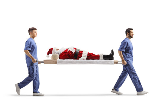Two male health workers carrying Santa Claus on a stretcher
