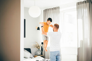 Cute daddy playing with son at Home. Father's Love, Parenting And Fatherhood Happiness Concept