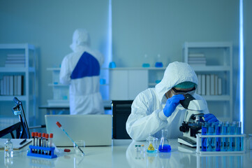 Scientist using microscope during experiment in laboratory, Science and technology healthcare concept