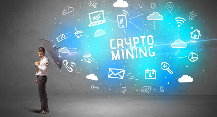 Businessman defending with umbrella from CRYPTO MINING inscription, modern technology concept