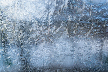Frosty patterns on the glass. Patterns of frost on the glass. Winter patterns. Macro