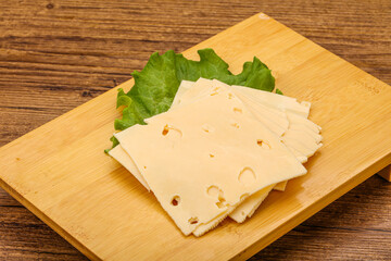 Sliced yellow cheese over board