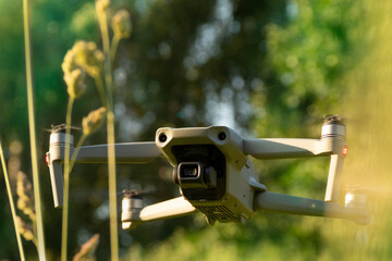 Gray mini quadcopter on nature background