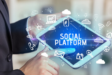 Close-up Of A Person Using Social Networking with SOCIAL PLATFORM inscription