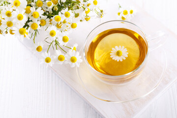Healthy chamomile tea in a glass teacup