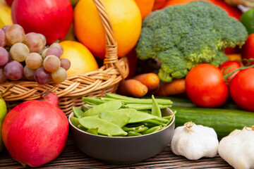 Group vegetables and Fruits Apples, grapes, oranges, and bananas in the wooden basket with carrots,...