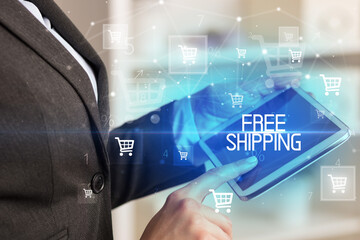 Young person makes a purchase through online shopping application with FREE SHIPPING inscription