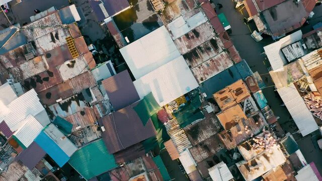 Aerial top down view of the slums and people among them